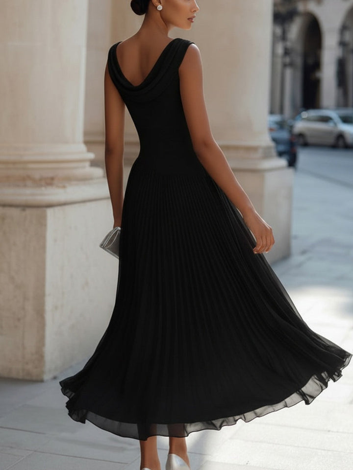 Draped neck sleeveless midi dress showing flowing pleated skirt detail